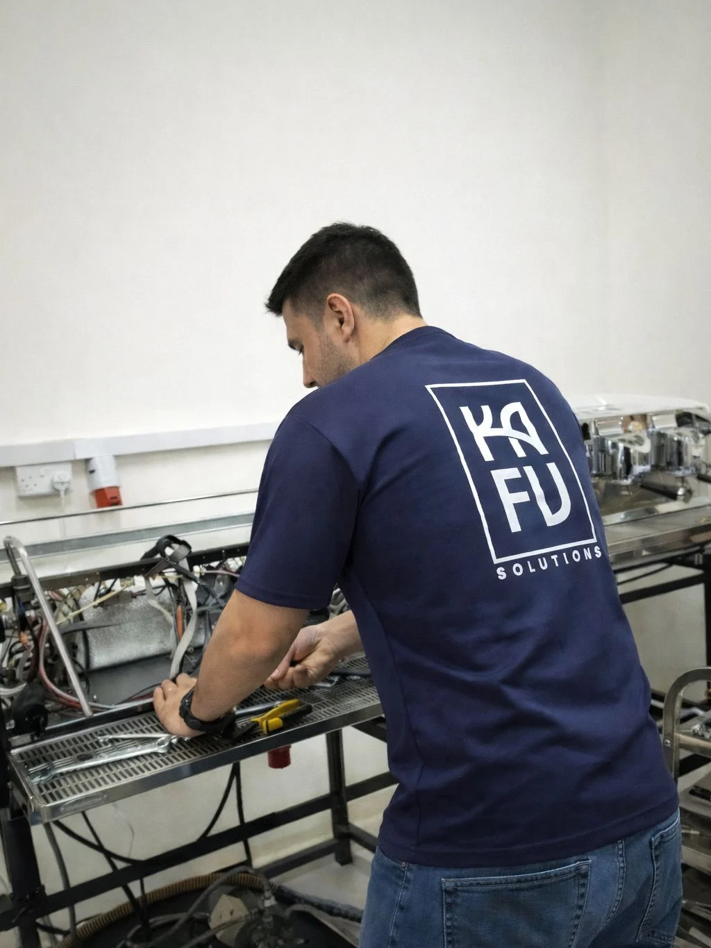 KAFU technician servicing an espresso machine